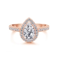 Macro shot of a pear-cut diamond ring with a halo and pave-set rose gold band - Pear Shape Rose Gold White Stone