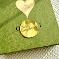 Detail of dark green embossed gift box with Feliz Cumpleaños gold sticker - Spanish Birthday Style 1 / Gold