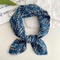 Navy blue cotton linen neck scarf with white floral print tied in a bow shape - Blue Bellflower