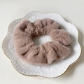 Soft faux rabbit fur scrunchie in dusty pink color on a white ceramic plate - Milk Tea