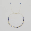 Beaded bracelet with faceted dark blue stones and gold square spacers on beige cord - Dark Blue
