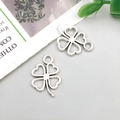 Detailed close-up of antique silver clover charms for DIY jewelry making and crafts - Heart-shaped Four-leaf Clover 11x17mm
