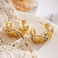 Irregular gold-plated C-shaped earrings with zircons shown on a lace fabric - 1.9cm x 0.8cm / Gold With Transparent Zirconia
