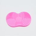 Macro detail of pink silicone makeup brush cleaning mat with various textures and suction cups - Small Apple Shape / Pink