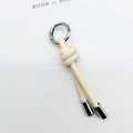 Detail of cream leather knot keychain with silver spring ring for bags and car keys - Beige