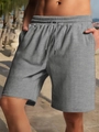 Close-up of men's heavy grey shorts featuring herringbone texture and drawstring waist - S / Marl Grey