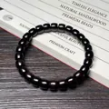 Bracelet ethnique en bois de santal vert avec perles cylindres sombres et grain naturel poli - Ébène du Mozambique 7x8mm