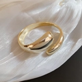 Minimalist gold open cuff bracelet with liquid lava drop design and mirror finish - Criss-cross Design / Gold