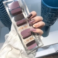 Detail showing purple and marble pattern nail polish wraps on a model with packaging - MZ-004 Purple Brown Marble