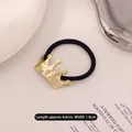 Elastic hair tie featuring a geometric golden crown accent, length 4.6cm and width 1.8cm - Crown Gold