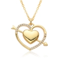 Macro shot of 18k gold heart pendant featuring sparkling zircons and a mirror reflection - Arrow Through Heart Style (c553)