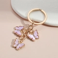 Pink pearl butterfly keychain with gold ring and crystals for bags and luggage - Purple