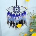 Detailed blue and white woven eye dreamcatcher with gradient hanging feathers on wall - Colorful Evil Eye