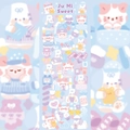 Close-up of cute cartoon cat stickers for DIY journals in soft pink and blue tones - Good Night