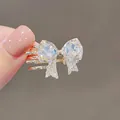 Handmade bow hair clip featuring sparkling clear crystals and gold plating finish - Crystal Bowknot