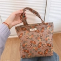 Detailed close-up of corduroy floral handbag with simple wish label and soft texture - Dark Coffee Floral