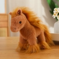Plush brown horse toy doll with soft orange-brown mane sitting on a wooden table - Brown Horse Doll