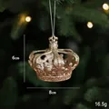 Champagne gold glitter crown Christmas ornament hanging on a festive green tree - Crown