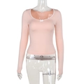 Detail of square neck pink top with lace trim and bow accent on white background - Pink