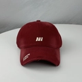 Detail of burgundy baseball cap with white NI embroidery and distressed torn brim - One Size (54-60cm) / Burgundy