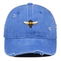 Close-up of vintage denim blue baseball cap with bee embroidery and distressed details - One Size / Light Blue