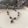 Detailed shot of tiger eye stone and pearl necklace with retro golden pendant on fabric - 17# Necklace-Silver-Round Ball
