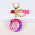 Letter O keychain with pink glitter resin, heart charm and fuchsia tassel pendant - Letter O