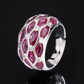 Adjustable silver ring with marquise red gems and sparkling clear zircons on black background - Ruby Red