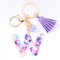 Detail of purple tassel and colorful resin letter W keychain with gold ring and charm - Letter W