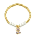 Gold beaded bracelet with white pearls and a purple flower zircon pendant on white background - Purple Flower Pendant