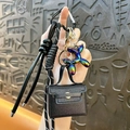 Black leather mini bag keychain with colorful balloon dog pendant and braided rope lanyard strap. - Black