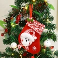 Knitted Christmas stocking with bear head and snowflake hanging on a decorated tree - Bear Style
