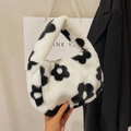 Detail of plush faux fur shoulder bag featuring a bold black and white floral pattern texture - White (Flower Pattern)