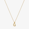 Macro shot of gold textured letter G pendant with sparkling diamond details on a fine chain - 925 Silver / Gold - Letter G