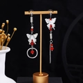 Detail of asymmetrical butterfly drop earrings with red beads and long silver tassels - E2520-2 (Silver Asymmetric Butterfly Tassel)