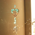 Detail of tree of life suncatcher with heart crystal prism and rainbow reflections - Turquoise Blue Heart