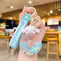 Cute Cinnamoroll keychain with sky blue silicone wristband and lucky charm detail - Donut Quicksand - Blue Puppy