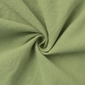 Close-up of sage green cotton fabric showing natural texture and soft drape detail - S / Green
