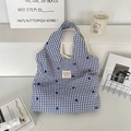 Detailansicht der blau-weiß karierten Canvas-Tasche mit Blumenstickerei und Markenetikett - Blaues Gitter Dunkelblaue Blume