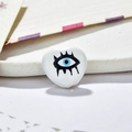 Detailed macro view of heart-shaped evil eye beads for DIY jewelry making on a tray - White