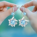 Elegant silver earrings with sparkling blue gemstone and flower halo detail - Blue Diamond Snowflake Earrings Led-76