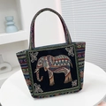 Ethnic blue canvas tote bag featuring intricate elephant embroidery and geometric patterns - Black Side Elephant