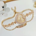 Close-up of golden heart-shaped watch with diamond bezel and adjustable drawstring chain - Gold