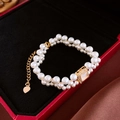 Close-up of double-layer pearl bracelet with gold square pendant in a luxury red box - Gold Double-layer Square Gemstone Pearl Bracelet