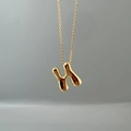 Macro shot of 3D bubble style gold letter H pendant on a polished link chain necklace - Letter N Single Pendant