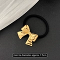 Golden hammered bow hair tie with 7.5cm black elastic band for a vintage metal look - Ribbon Bow Gold
