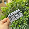 Close-up of semi-transparent acrylic hair claw clip with black barcode pattern and numbers - Barcode Cow - Acrylic Hair Claw