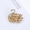 Elegant gold swan brooch with champagne crystals and sparkling rhinestones on white - Gold Champagne Swan