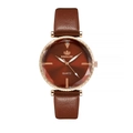 Detail of rose gold watch case with faceted glass and red radial dial on brown strap - Brown