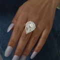 Macro view of luxurious silver pear-shaped ring with pavé crystals on blue denim background - Adjustable Open / Silver Waterdrop Style (6030S)